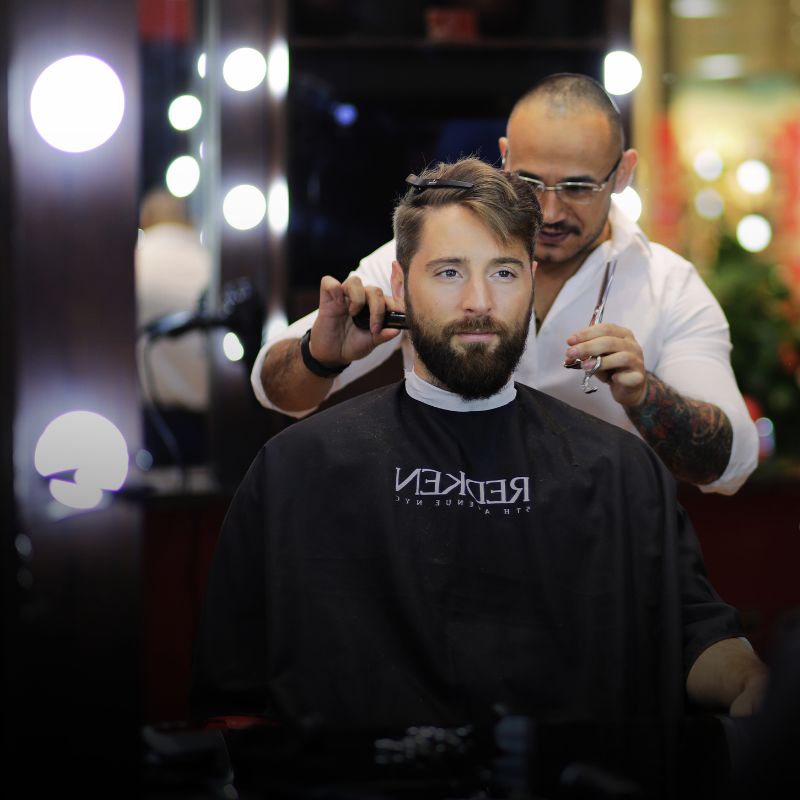 A man gets his hair cut and beard styled at Jazz Lounge Spa.